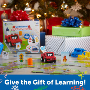 Kid engaging with toy fire truck and car from Switcheroo Coding Crew.