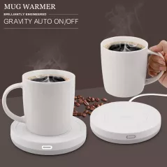 A white mug filled with latte art sits on a sleek white heating coaster, with steam rising from the cup.