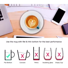A white mug filled with latte art sits on a sleek white heating coaster, with steam rising from the cup.
