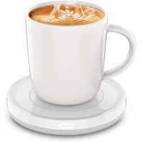 A white mug filled with latte art sits on a sleek white heating coaster, with steam rising from the cup.