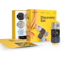 Colorful Cubelets Discovery Set with interactive blocks and guidebook on yellow background.