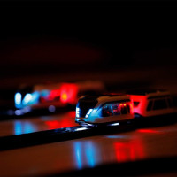 Sleek smart train on curved track with box, for kids ages 3–99, features shown.