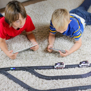 Sleek smart train on curved track with box, for kids ages 3–99, features shown.